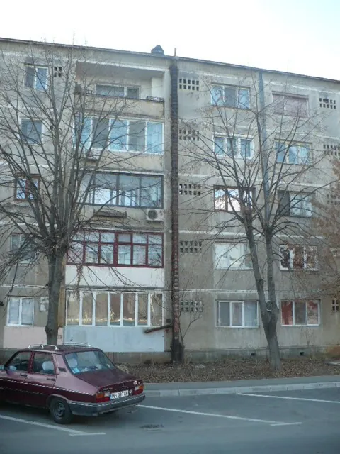 Bloc de locuințe cu un coș de fum lipit de fațadă, de jos până deasupra acoperișului